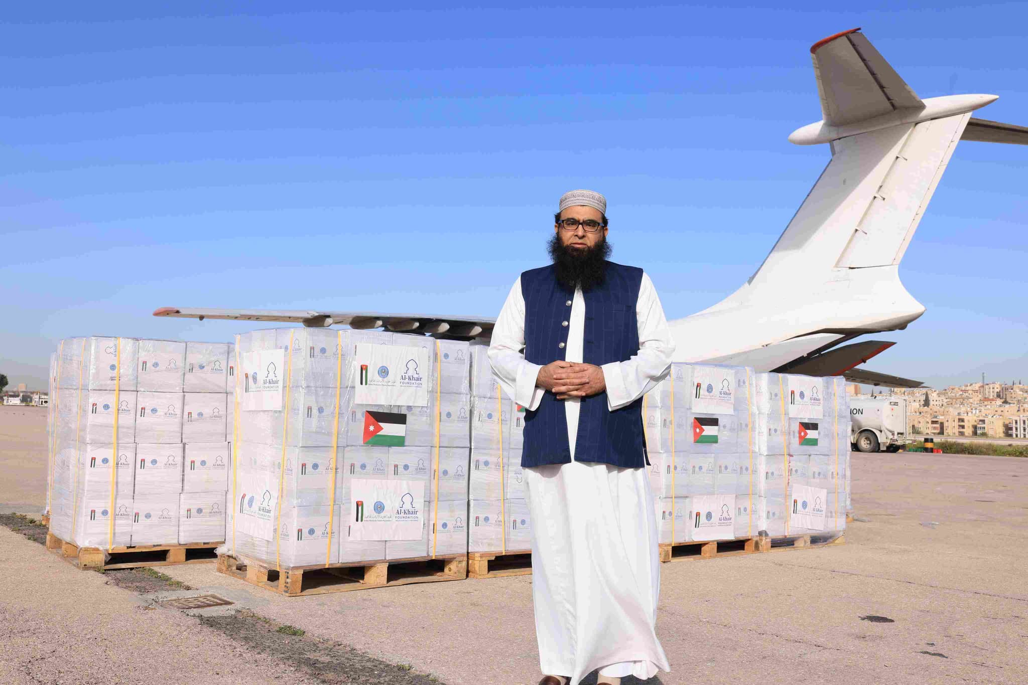 Imam Qasim delivering aid